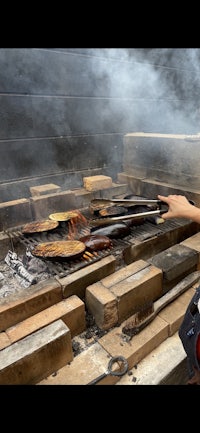 Eggplants grilled outside over live fire coals