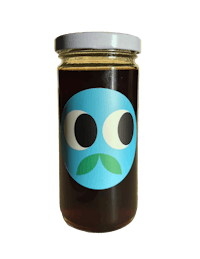 a jar of honey with a blue face on it